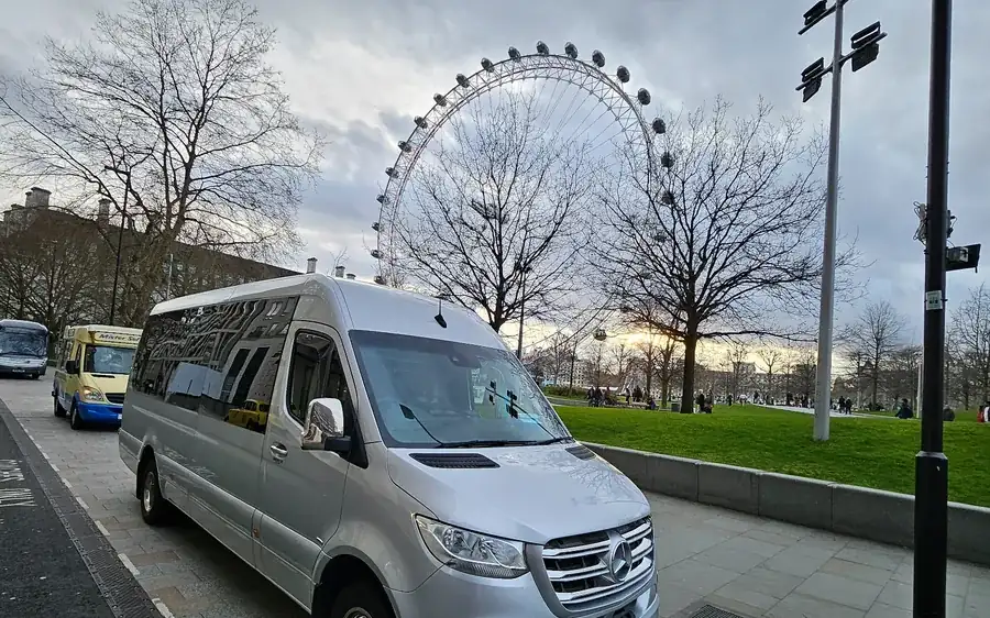 Silver Mercedes Sprinter 16-seat minibus parked by the London Eye